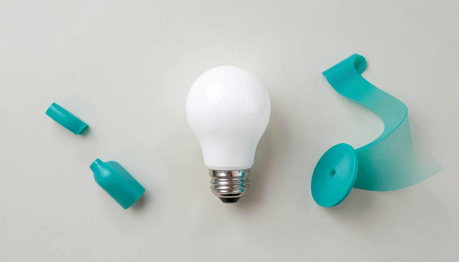 A cool white LED bulb with a crisp, clean glow on a light neutral surface